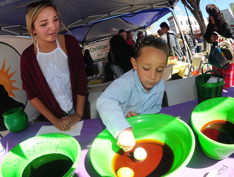 Tyler Donovan with his sister Sarah colors an egg during the Great Prescott Easter Egg Hunt Saturday morning on the Yavapai County Courthouse Plaza.(Les Stukenberg/The Daily Courier)