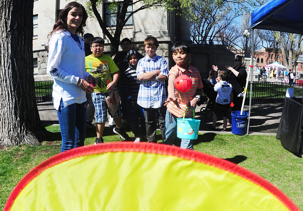 Gian Ando tosses a ball at the target during the Great Prescott Easter Egg Hunt Saturday morning on the Yavapai County Courthouse Plaza.(Les Stukenberg/The Daily Courier)
