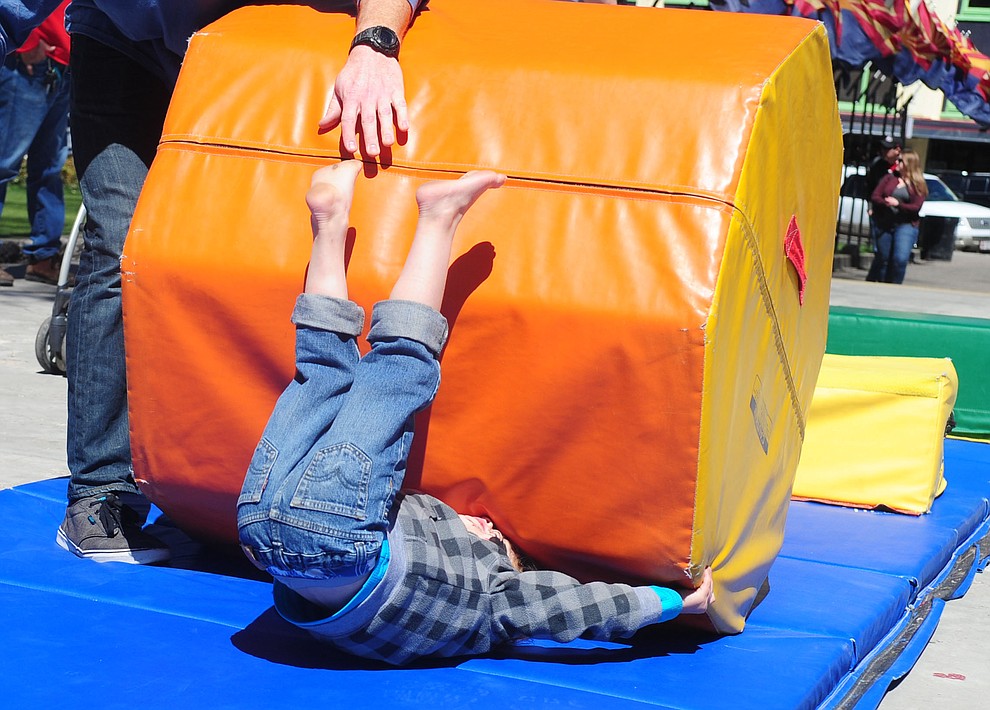 Brody Scott, four from Phoenix, goes tumbling in the Flip City Gymnastics obstacle course during the Great Prescott Easter Egg Hunt Saturday morning on the Yavapai County Courthouse Plaza.(Les Stukenberg/The Daily Courier)