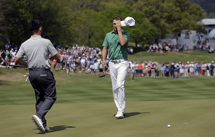 Jordan Spieth, right, reacts after missing a putt on the 16th green during the round of 16 play against Louis Oosthuizen, left, at the Dell Match Play Championship golf tournament at Austin County Club, Saturday, March 26, in Austin, Texas. Speith lost the hole and the match.