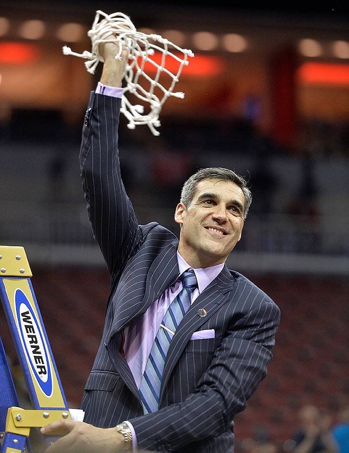 Villanova head coach Jay Wright hold a portion of the net after his team defeated Kansas 64-59 on Saturday.