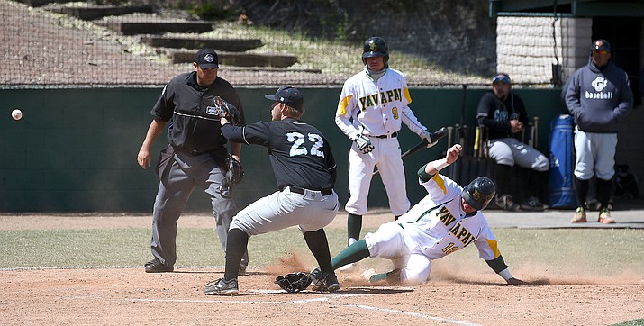 Yavapai's Ryan Oberg (18) safely slides across home plate while Chandler-Gilbert's Trevor Cross (22) catches the throw and batter Dylan Enwiller (9) looks on Tuesday afternoon March 29, 2016 at Roughrider Park. (Matt Hinshaw/The Daily Courier)