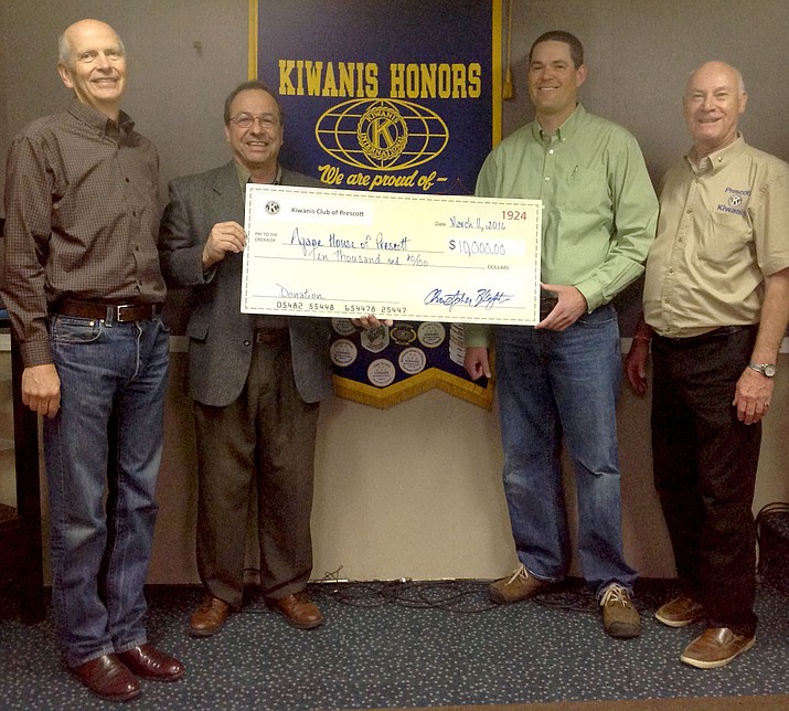Agape House board members accept $10,000 from the Kiwanis of Prescott to kick off their new building fund to house homeless families in the Quad Cities. 