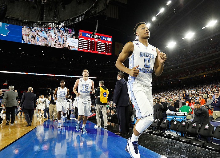 North Carolina player Nate Britt (0) leaves the court after the NCAA Final Four tournament college basketball semifinal game against Syracuse Saturday, April 2, in Houston. North Carolina won 83-66.