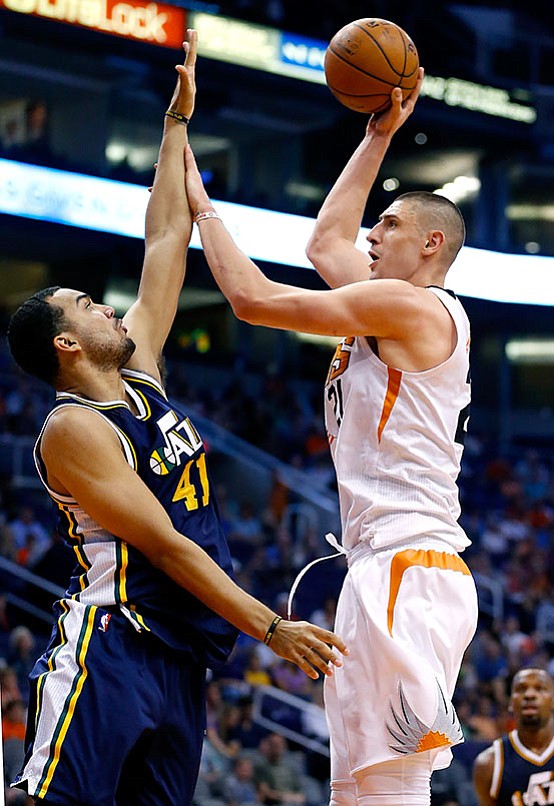 Phoenix Suns center Alex Len (21) shoots over Utah Jazz forward Trey Lyles (41) during the second half of an NBA basketball game, Sunday, April 3, in Phoenix.