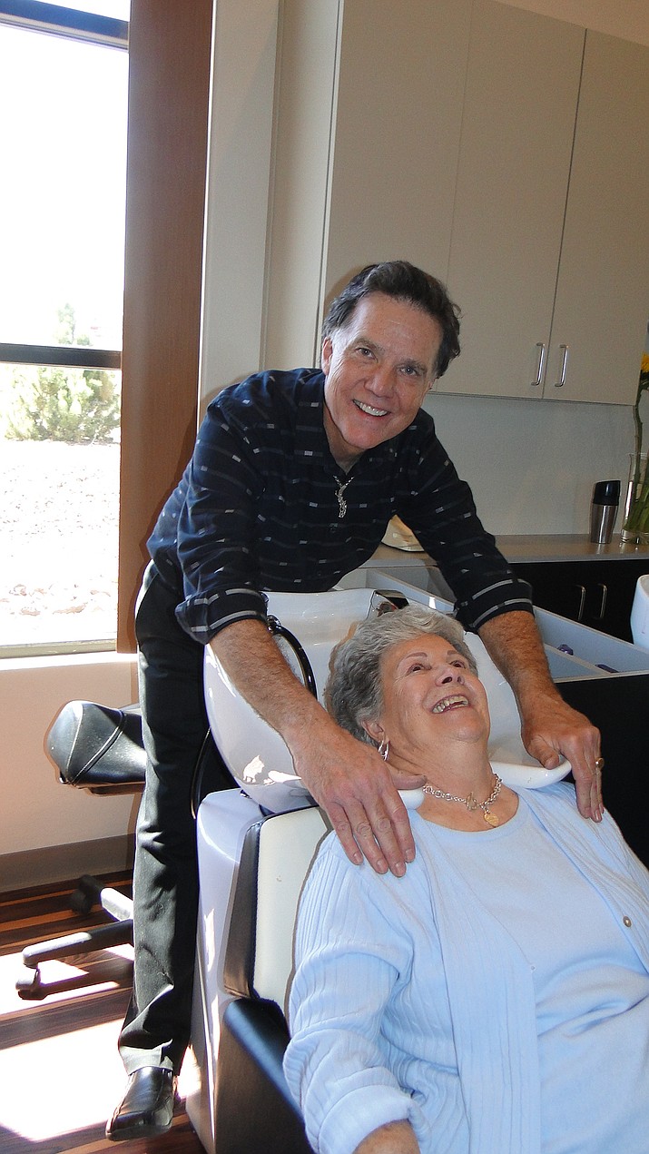 Owner Bruce Farkas works with Jean Chester at the B. Alan Hair Studio’s new location in Dewey.