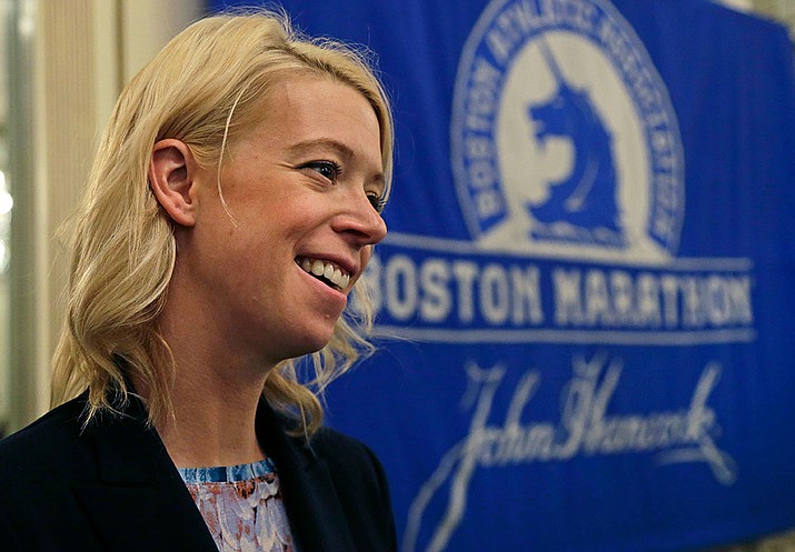 Adrianne Haslet, a 2013 Boston Marathon survivor, speaks at a news conference, Thursday, April 14, in Boston after receiving the Patriots' Award, which is annually given to a New England-based individual, group, or organization that is patriotic, philanthropic, and inspirational, and fosters goodwill and sportsmanship. 