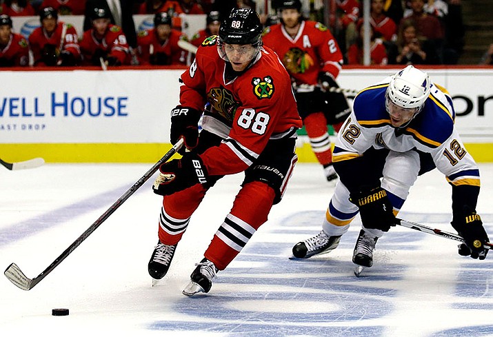 Chicago Blackhawks right wing Patrick Kane, left, controls the puck against St. Louis Blues center Jori Lehtera during the second period Sunday, April 17, in Chicago. 