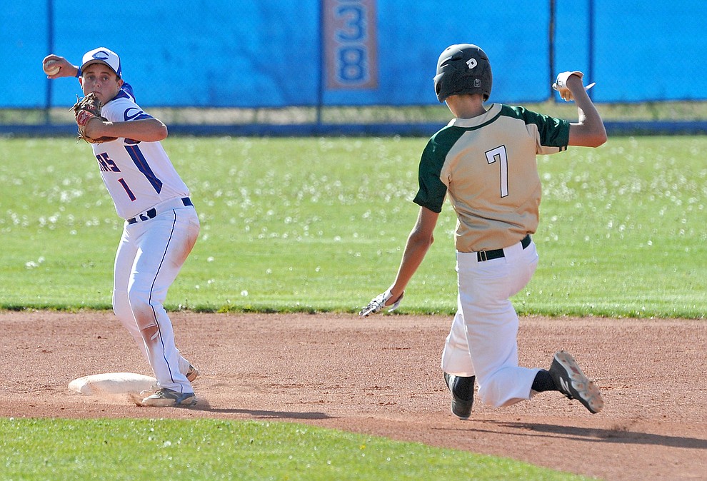 Chino Valley's Skylar Brooks (1) turns a double play while Mohave's Bjorn Syme (7) slides into second base Tuesday afternoon April 19, 2016 during Chino's last regular season home game at Chino Valley High School. (Matt Hinshaw/The Daily Courier)