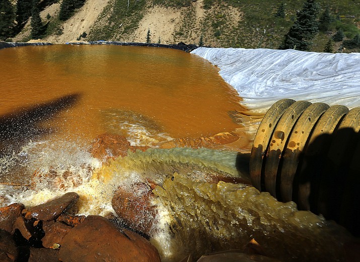In this Aug. 14, 2015 file photo, water flows through a series of retention ponds built to contain and filter out heavy metals and chemicals from the Gold King mine chemical accident, in the spillway about 1/4 mile downstream from the mine, outside Silverton, Colo. Researchers who studied a river in Colorado after a massive mine spill say runoff from fall storms kicked up the levels of some contaminants in the water but not others.