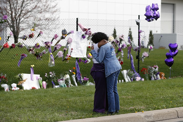 Fans embrace by a makeshift memorial outside Paisley Park, the home of singer Prince, on Thursday, April 21, 2016 in Chanhassen, Minn. The singer died Thursday at the age of 57. 