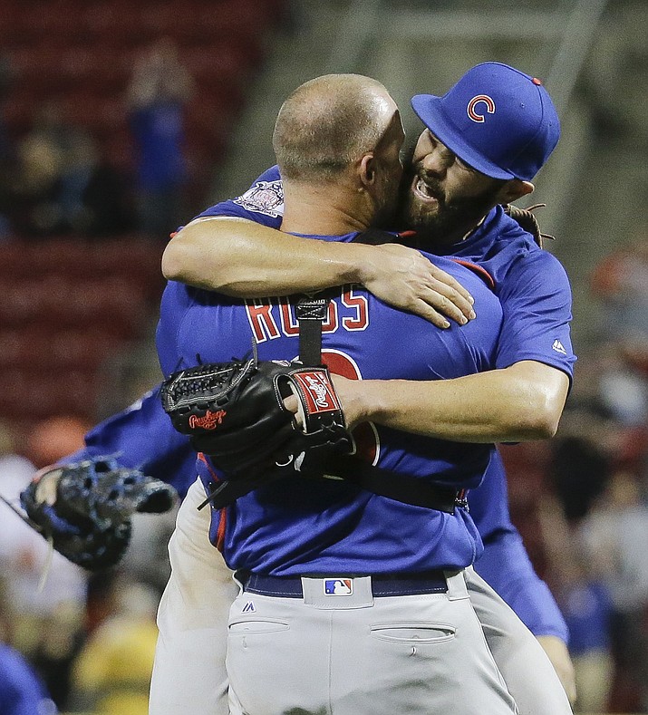 Chicago Cubs starting pitcher Jake Arrieta, right, celebrates with catcher David Ross after the final out of his no-hitter baseball game against the Cincinnati Reds in Cincinnati. Expectations for both Chicago baseball teams this year are high as the Cubs and White Sox lead their perspective leagues three weeks into the season.