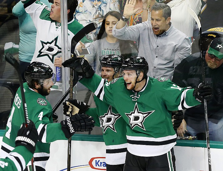 Dallas Stars center Radek Faksa, right, celebrates his goal with left wing Antoine Roussel (21) and defenseman Jason Demers (4) against the St. Louis Blues during the third period of Game 1 of the NHL hockey Stanley Cup Western Conference semifinals, Friday, April 29, 2016, in Dallas. The Stars won 2-1.