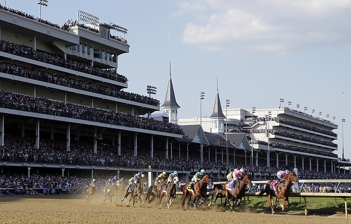 In this May 2, 2015, file photo, horses make their way around turn one during the 141st running of the Kentucky Derby horse race at Churchill Downs in Louisville, Ky. American Pharoah (18), fourth from right, won the race, and eventually won the coveted Triple Crown.