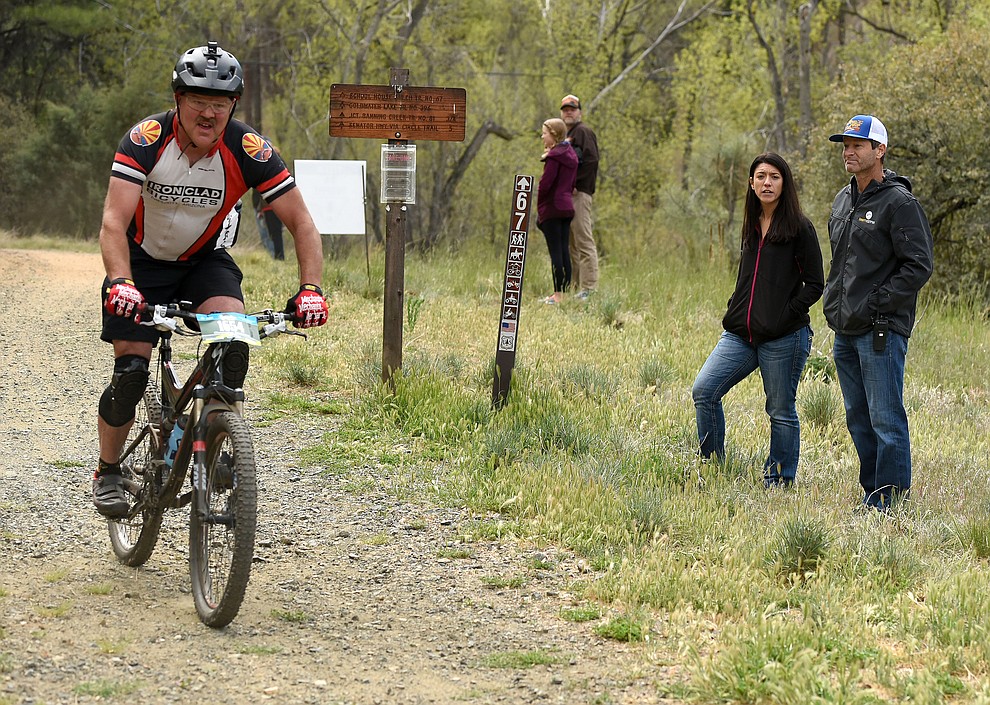 Todd Sadow President of Epic Rides and co-founder of the Whiskey Off-Road mountain bike race watches a 30 Proof rider go through the course Saturday morning April 30, 2016 during the 13th Annual Whiskey Off-Road in Prescott. (Matt Hinshaw/The Daily Courier)