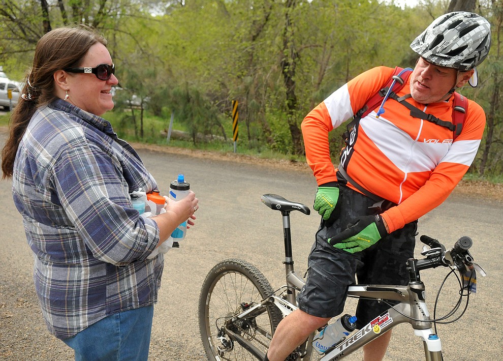 Daily Courier Editor Robin Layton hands her husband Chuck a bottle of water while he competes in the 30 Proof Saturday morning April 30, 2016 during the 13th Annual Whiskey Off-Road in Prescott. (Matt Hinshaw/The Daily Courier)