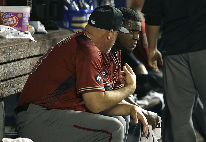 Arizona Diamondbacks starting pitcher Rubby De La Rosa, right, talks with pitching coach Mike Butcher after pitching in the third inning against the Miami Marlins, Wednesday, May 4, in Miami. De La Rosa gave up three runs in the inning. 