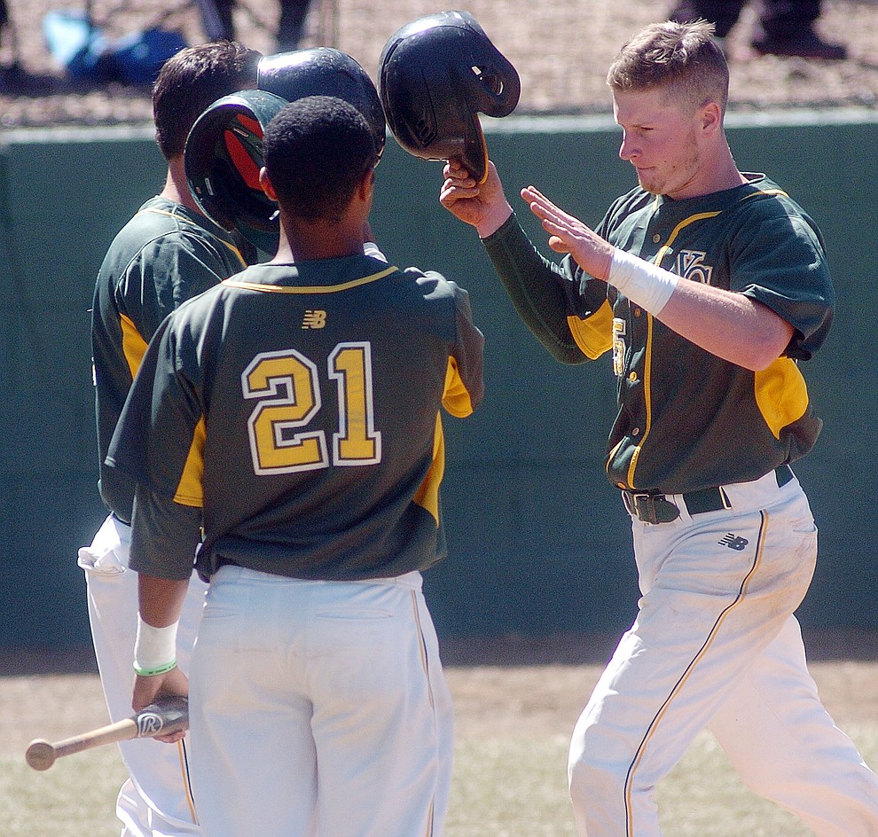 Yavapai's Gavin Johns, at right, trots home and gets congratulated after his solo home run over the center field fence in the first game of the NJCAA Region 1 Division 1 semifinals Thursday in Prescott. (Les Stukenberg/The Daily Courier) (Les Stukenberg/The Daily Courier)