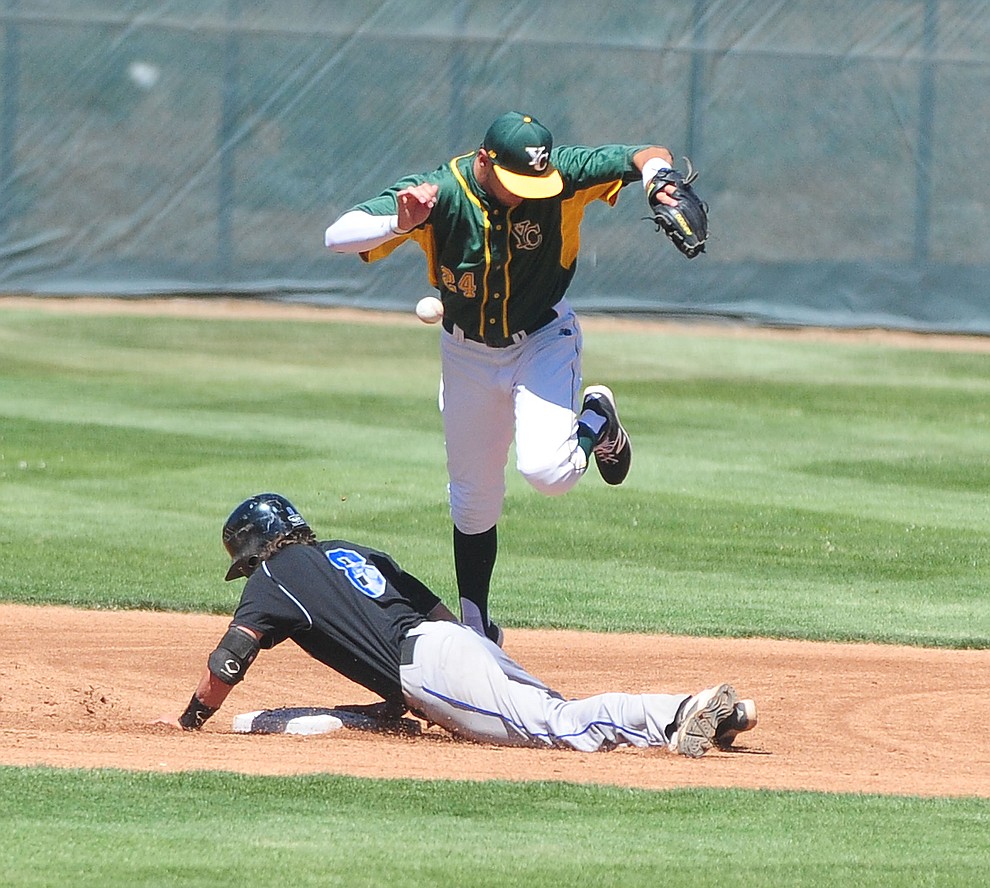 Yavapai's Ramsey Romano (24) misses the catch as South Mountain's Nick Lacayo slides safely into second in the first game of the NJCAA Region 1 Division 1 semifinals Thursday in Prescott. (Les Stukenberg/The Daily Courier)