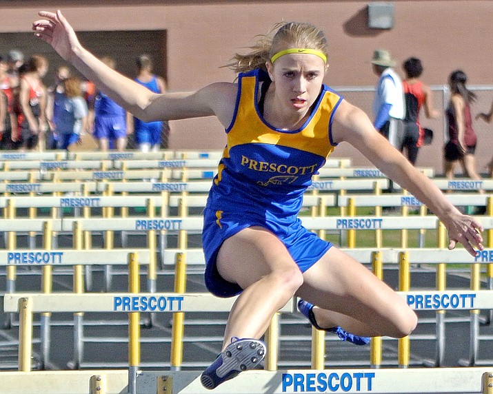 Prescott's Makennah Mills clears a hurdle during the 100M hurdles in a 2015 meet at Prescott High School. (Matt Hinshaw/The Daily Courier)