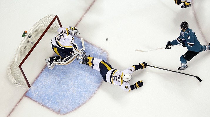 San Jose Sharks' Joe Pavelski (8) scores past Nashville Predators' Shea Weber (6) and goalie Pekka Rinne during Game 7 in an NHL hockey Stanley Cup Western Conference semifinal series Thursday, May 12, in San Jose, Calif.