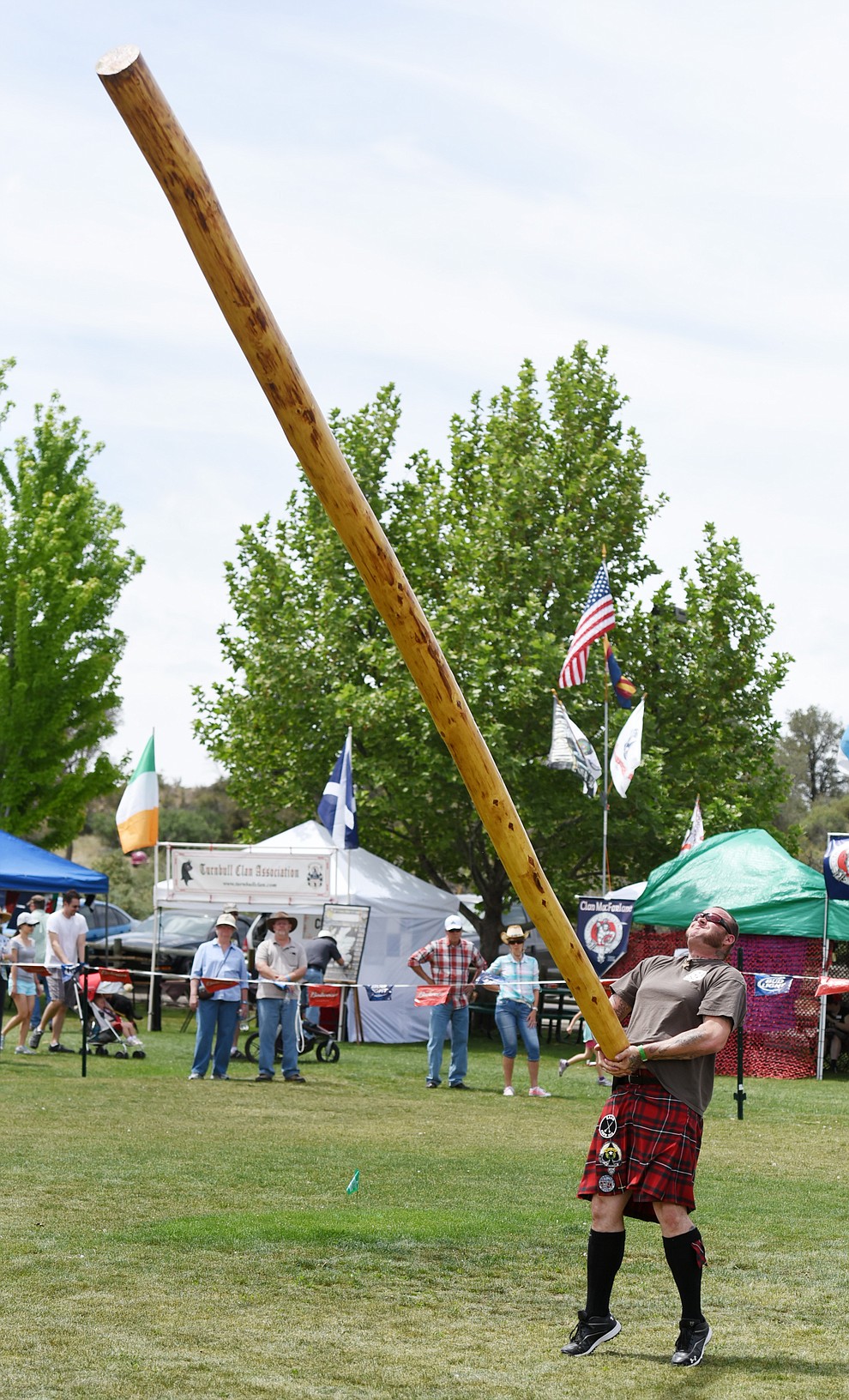 A participant tosses a log in the caber toss during the 2016 Highland Games Saturday morning in at Watson Lake Park in Prescott. (Les Stukenberg/The Daily Courier)