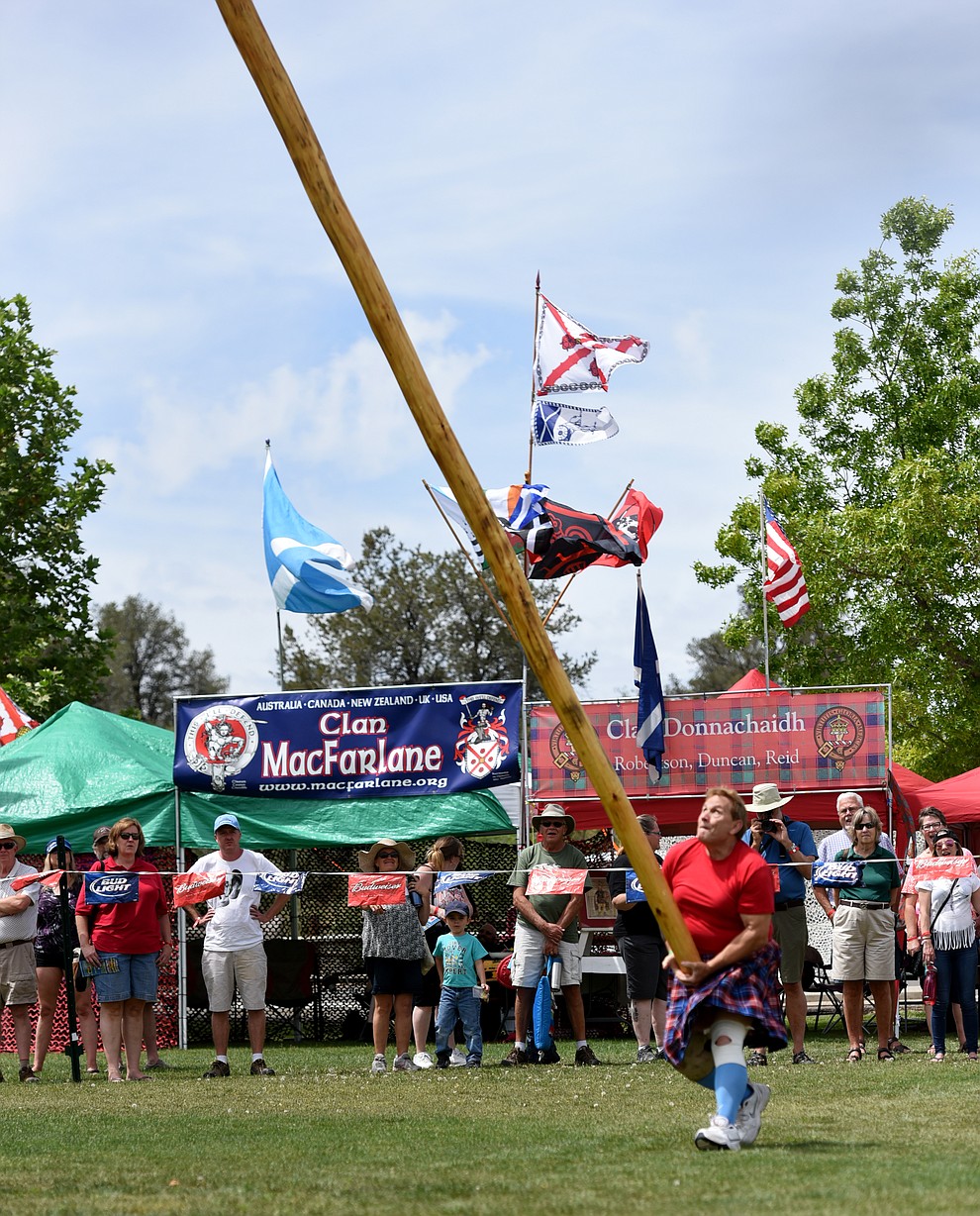 A contestant sends the caber down field during the 2016 Highland Games Saturday morning in at Watson Lake Park in Prescott. (Les Stukenberg/The Daily Courier)
