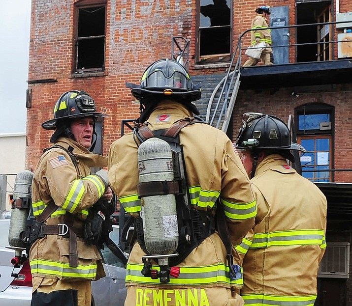 Prescott Fire personnel respond to a fire in the Downtown Prescott Inn (formerly the AJ Head Hotel) in the 100 block of North Cortez Street on Dec. 23, 2015, during the lunch hour.