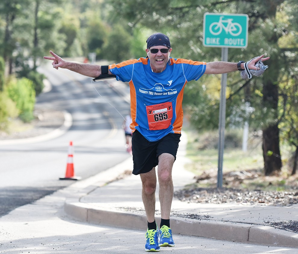 Local businessman Greg Raskin tries to fly up Hassyampa Village Lane in the 38th annual Whiskey Row Marathon Saturday morning in Prescott. (Les Stukenberg/The Daily Courier)