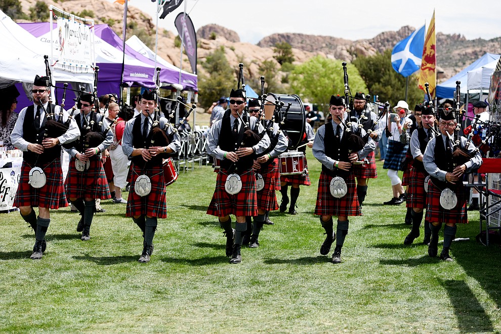 The Phoenix Pipe Band marches through the vendors and spectators during the 2016 Highland Games Saturday morning at Watson Lake Park in Prescott. (Les Stukenberg/The Daily Courier)