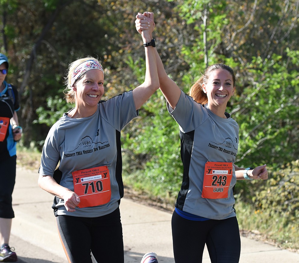 Having a little motivation with a running partner helps in the 38th annual Whiskey Row Marathon Saturday morning in Prescott. (Les Stukenberg/The Daily Courier)