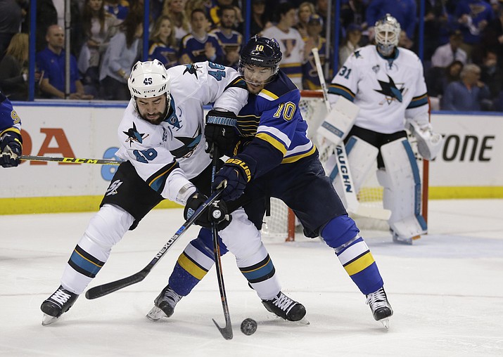 San Jose Sharks defenseman Roman Polak, left, battles for the puck against St. Louis Blues right wing Scottie Upshall during the second period in Game 1 of the NHL hockey Stanley Cup Western Conference finals, Sunday, May 15, in St. Louis. 