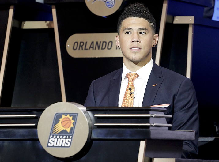 Phoenix Suns guard Devin Booker listens as the results of the NBA basketball draft lottery are announced Tuesday in New York (Julie Jacobson/Associated Press).