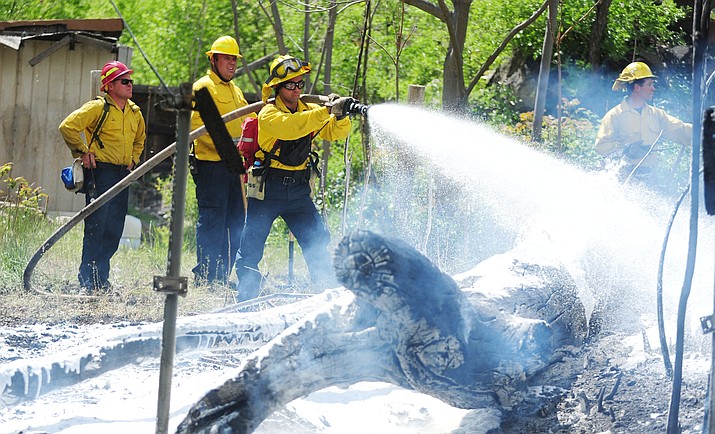 City of Prescott firefighters work to extinguish hotspots in a small wildland fire in downtown Prescott. Changes to the Public Safety Personnel Retirement System were approved by voters Tuesday, May 17.