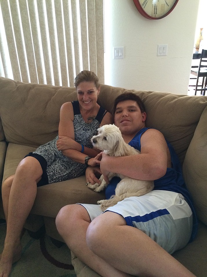 Matthew Camacho, 23, and his mother, Kat, relax with the family pets after his latest medical study.