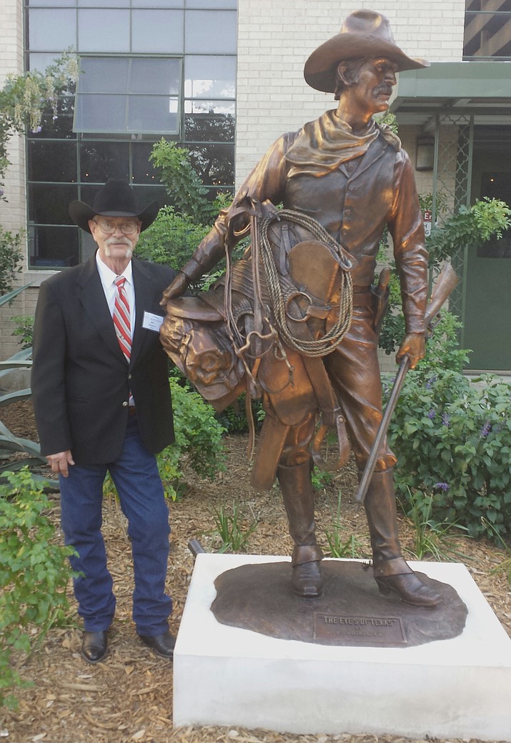 Bill Nebeker stands with one of his bronze works.