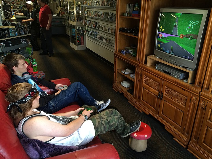 Bradley Pierman, front, and James Hill play Mario Kart 64 on Nintendo 64 at Black Box Gaming, a video game/stay and play store that recently opened in Prescott Valley.