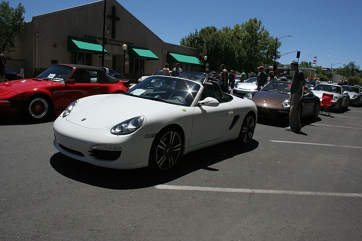 Porsches shine, lined up nose-to-tailalong South Cortez Street.