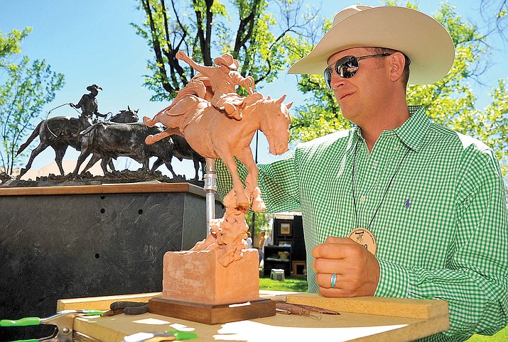 Sculptor Greg Kelsey of Colorado works on one of his pieces during the 2010 Phippen Museum Western Art Show and Sale at courthouse plaza in Prescott.