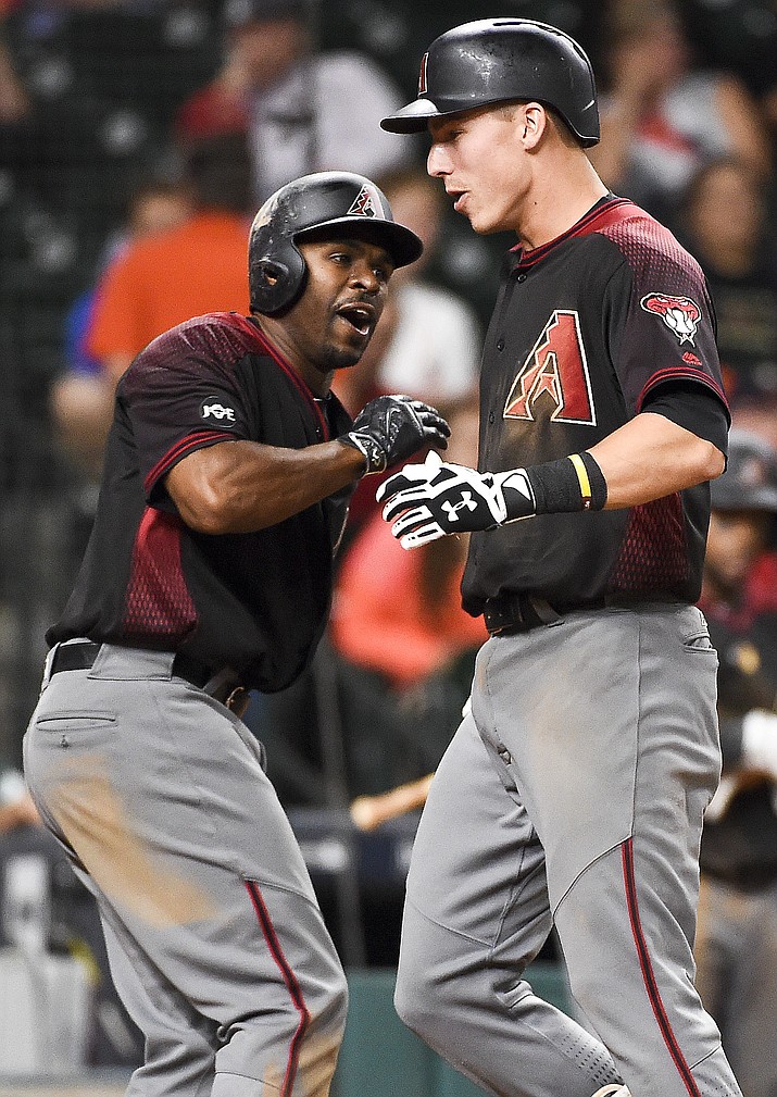 Diamondbacks' Jake Lamb, right, celebrates his game-tying two-run home run off Houston Astros relief pitcher Luke Gregerson with Michael Bourn during the ninth inning Wednesday, June 1.