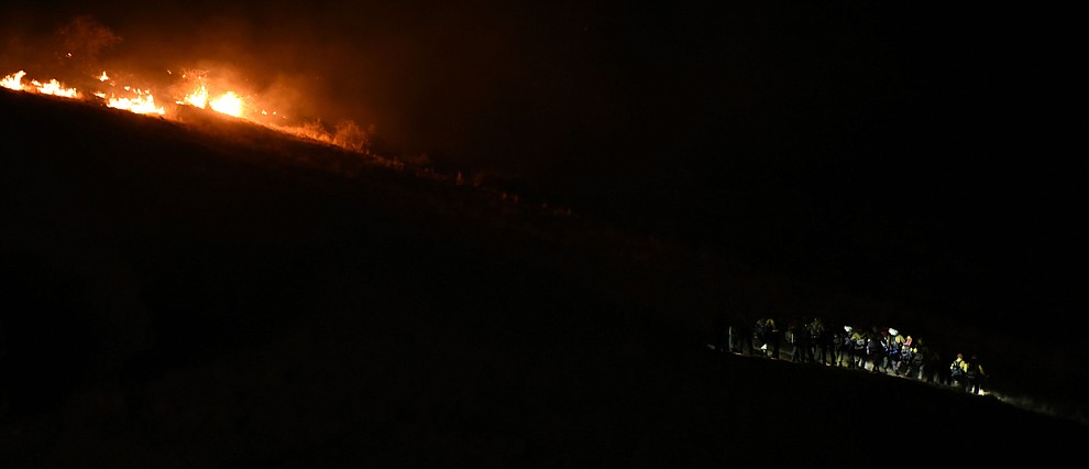 The Truckee Hotshots head to the east edge of the fire as they, Central Arizona Fire and National Forest firefighters worked to contain a wildland fire northeast of Coyote Springs Road and Pronghorn Lane in Prescott Valley Thursday night. (Les Stukenberg/The Daily Courier)