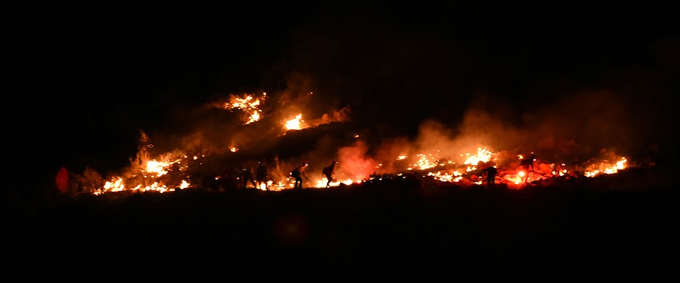 Firefighters work the western edge of the fire as Central Arizona Fire, Truckee Hotshots and National Forest firefighters worked to contain a wildland fire northeast of Coyote Springs Road and Pronghorn Lane in Prescott Valley Thursday night. (Les Stukenberg/The Daily Courier)