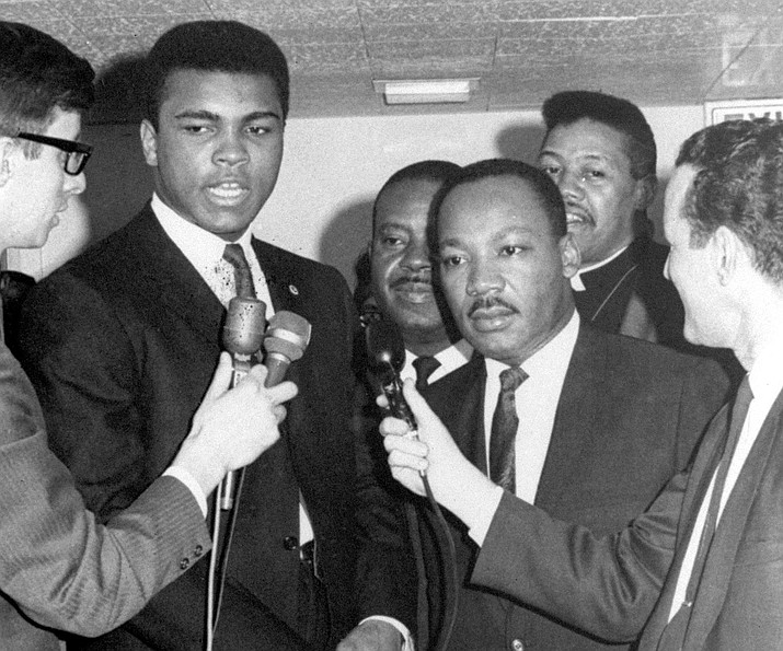 In this March 29, 1967, file photo, heavyweight champion Muhammad Ali, center left, and Dr. Martin Luther King speak to reporters. Ali, the magnificent heavyweight champion whose fast fists and irrepressible personality transcended sports and captivated the world, has died according to a statement released by his family Friday, June 3, 2016. He was 74.