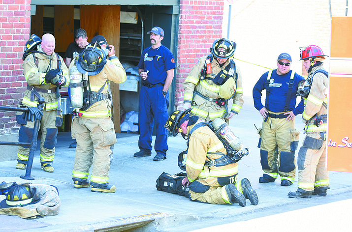 Prescott and Central Arizona fire fighters prepare to enter a potential hazmat scene in the laundry area of the Hotel St. Michael in downtown Prescott Tuesday morning.