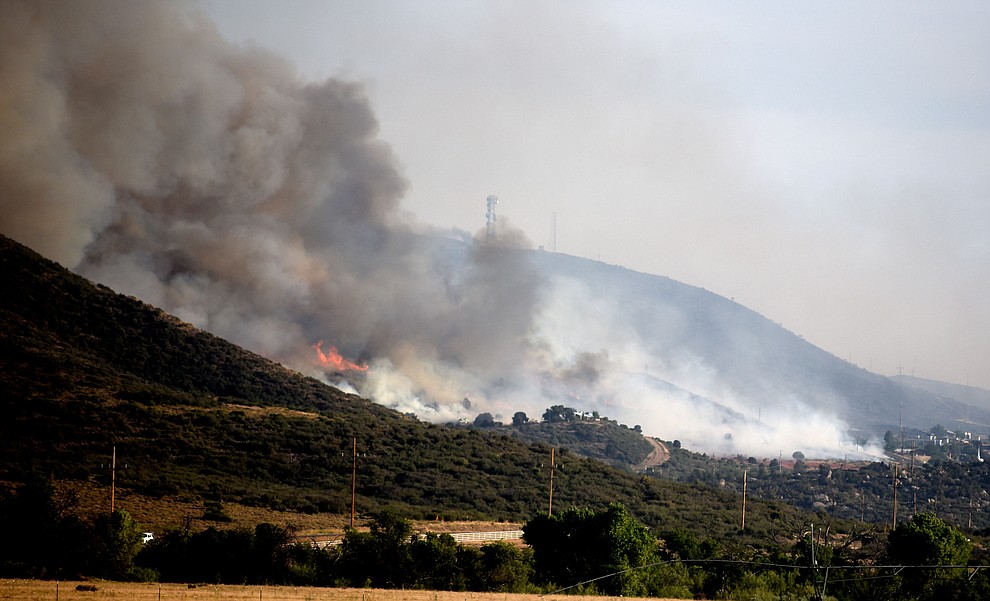 Fire burns through the hills on the south side of Yarnell Wednesday afternoon. (Les Stukenberg/The Daily Courier)