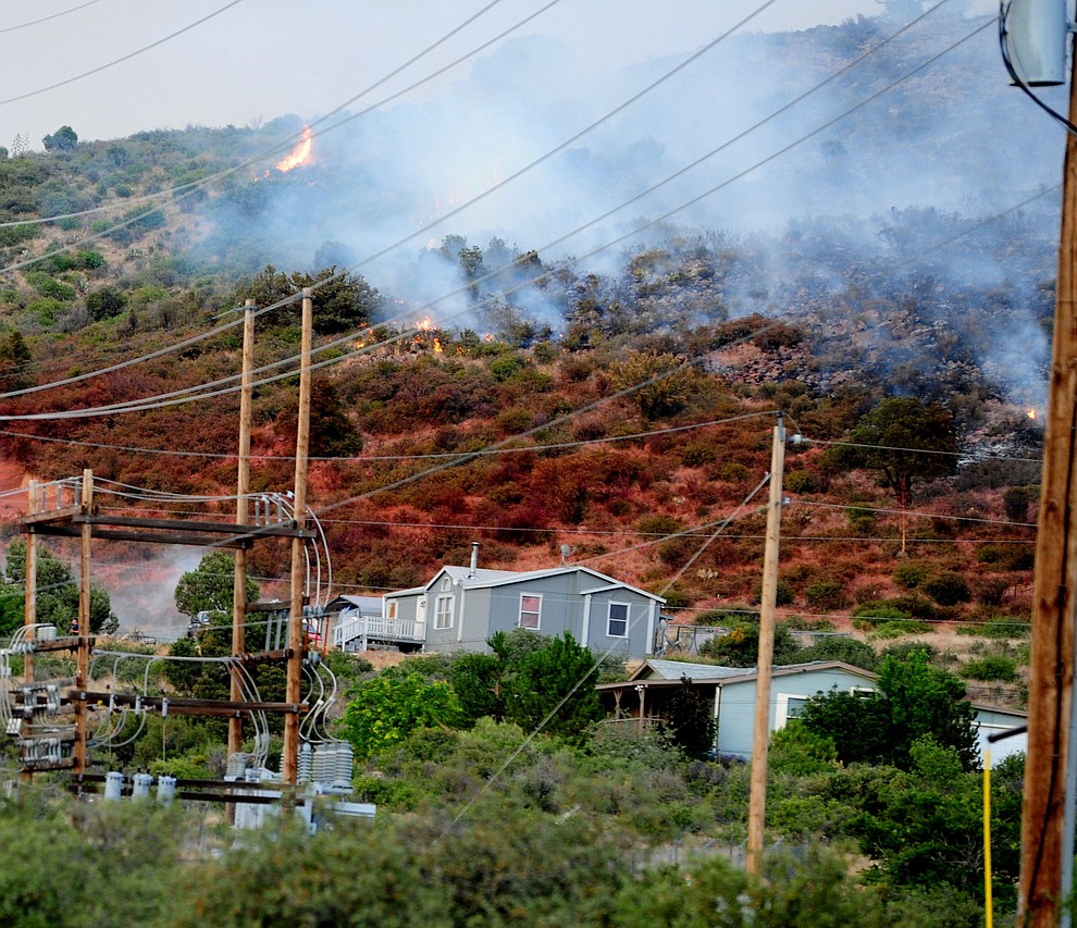 A slurry drop saved homes and power lines as fire burns through the hills on the south side of Yarnell Wednesday afternoon. (Les Stukenberg/The Daily Courier)