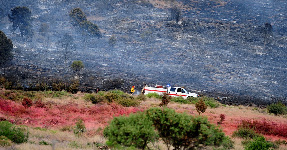 A fire crew gets a wet line down along with the line of slurry saving homes and businesses Fire burns through the hills on the south side of Yarnell Wednesday afternoon. (Les Stukenberg/The Daily Courier)