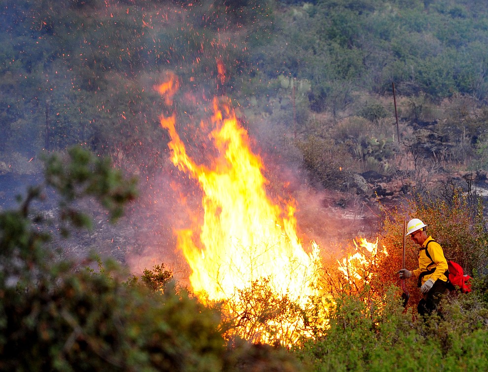 Hot spots crop up as fire burns through the hills on the south side of Yarnell Wednesday afternoon. (Les Stukenberg/The Daily Courier)