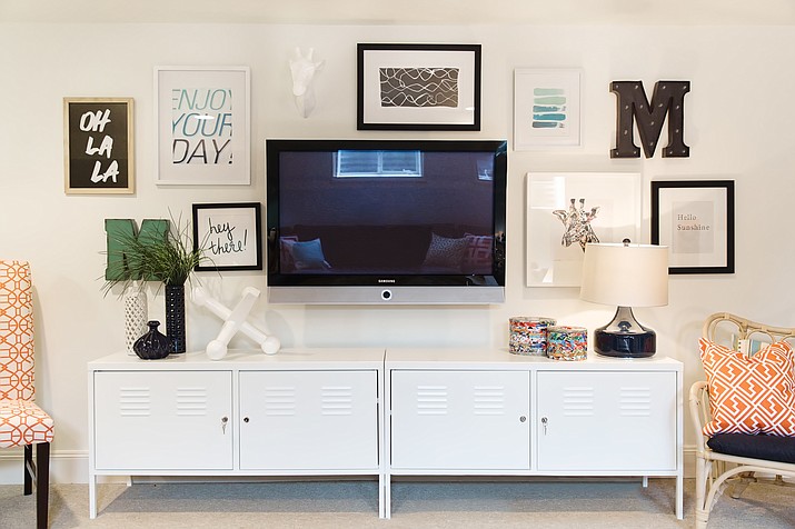 This undated photo provided by HGTV shows a room with a television creatively mounted on the wall that keeps it from standing out too much or detracting from the design of the rest of the room. 