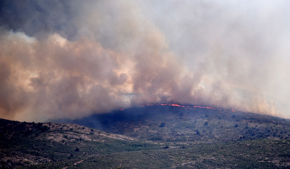 Flames hit a ridgeline on the Tenderfoot Fire near Yarnell Thursday afternoon. (Les Stukenberg/The Daily Courier)